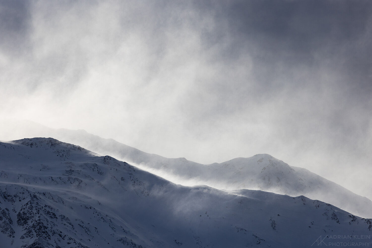 70 mph wind whipping up fresh snow on mountain peaks in Alaska near Anchorage. After finishing a fat tire bike ride in a more...