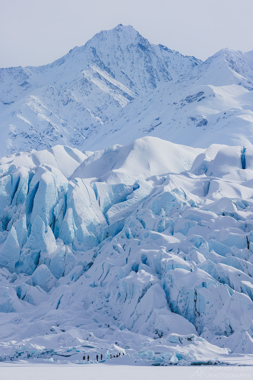 Ice hikers on the glacier in winter providing a sense of scale. The other photos on this page show a much closer view and in...