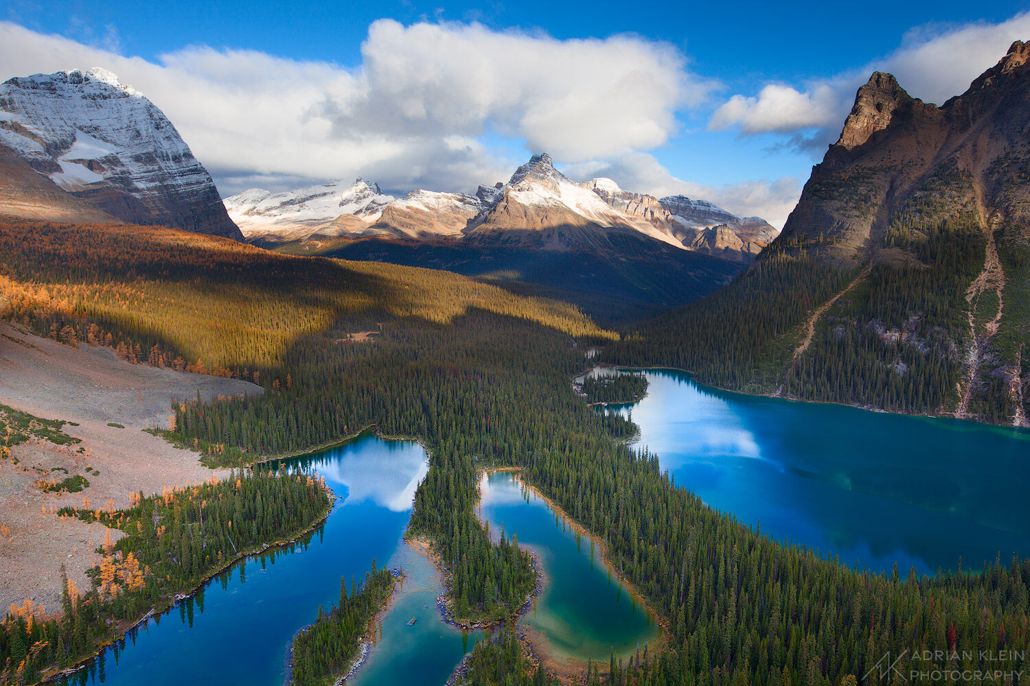 Standing on the edge of a cliff enjoying a sunrise view above Lake Ohara in Canada during fall. Yoho National Park of British...