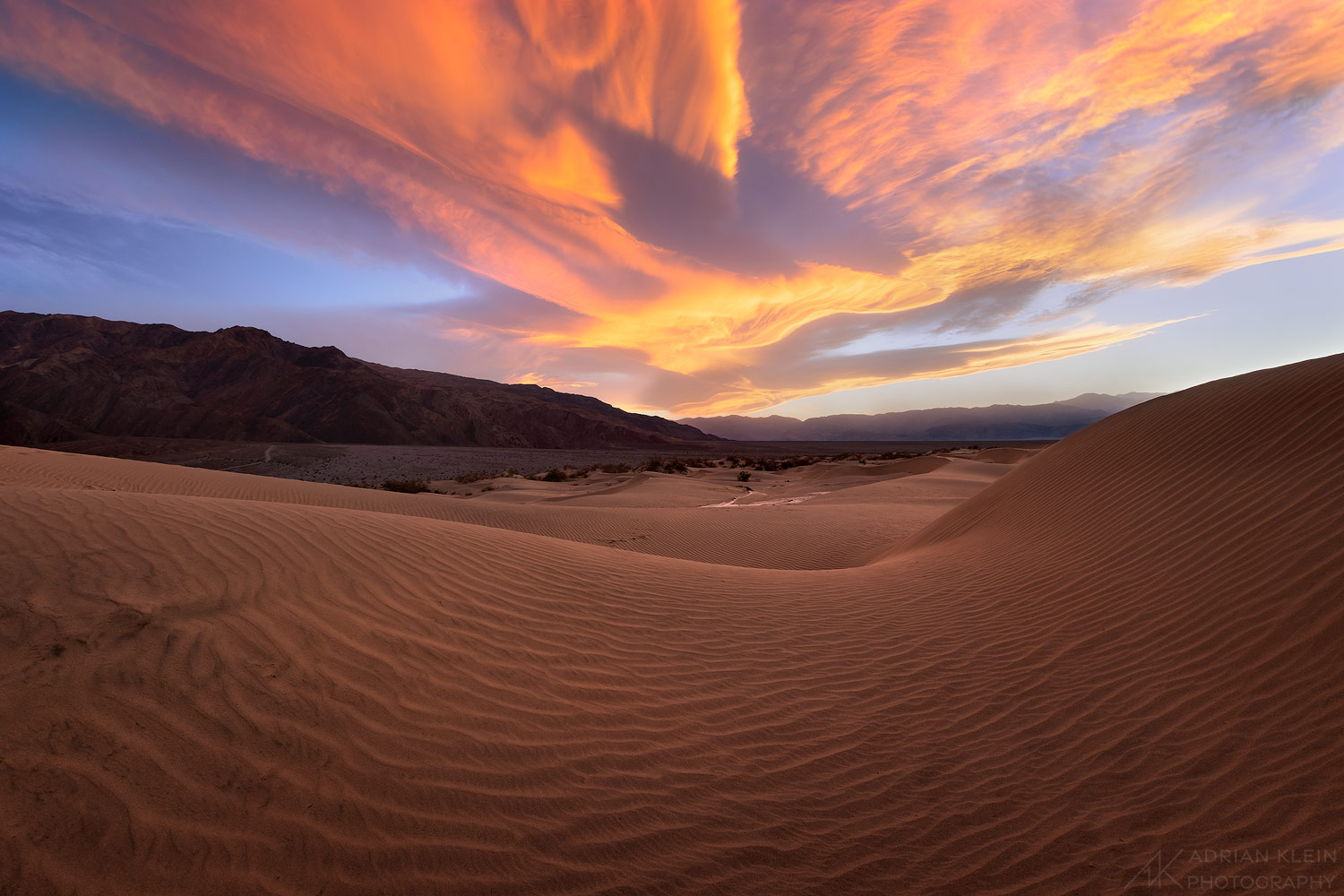 A sierra wave glows brightly over Death Valley at sunset.