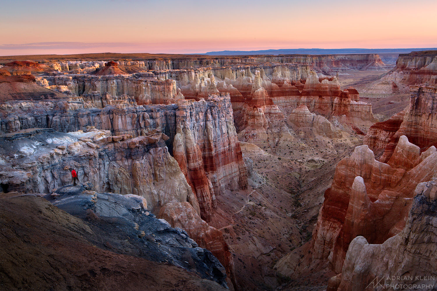 My friend David stands along the cliff edge watching the sunrise at Coal Mine Canyon, Arizona.
