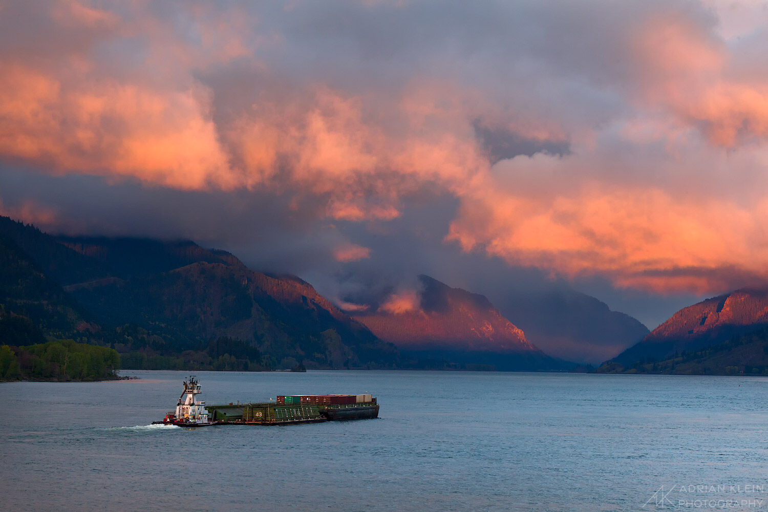 A barge makes it's way down the Columbia River through Hood River on a vibrant spring morning after an overnight storm starts...
