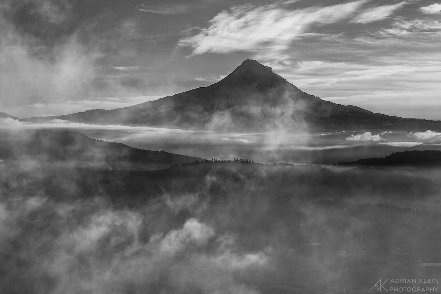 Mount Hood's North side sitting in the afternoon shadow as low clouds clear from the valley.