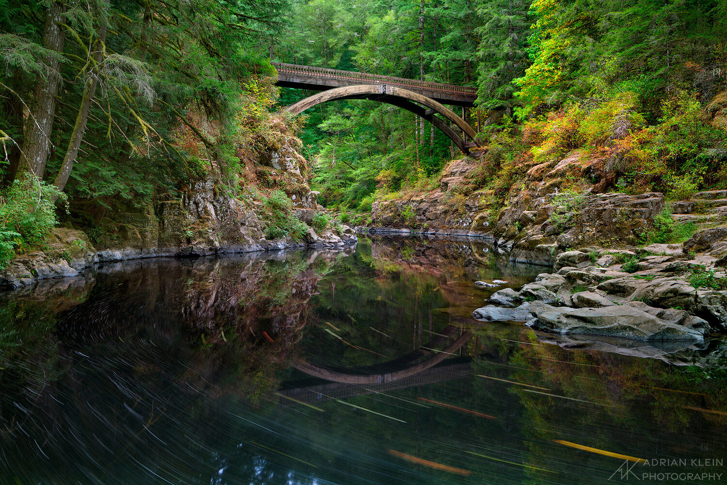 The Moulton Falls Bridge on the East Fork Lewis River in Washington with just a touch of fall foliage starting to show.