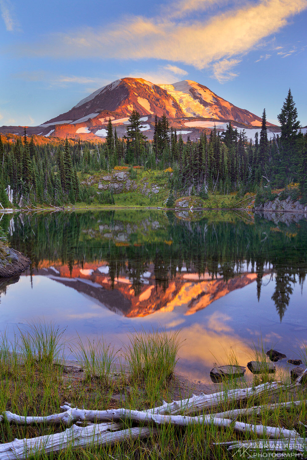Mount Adams glows and reflects during a late summer, early fall  sunset in the high backcountry along a nameless lake. Limited...