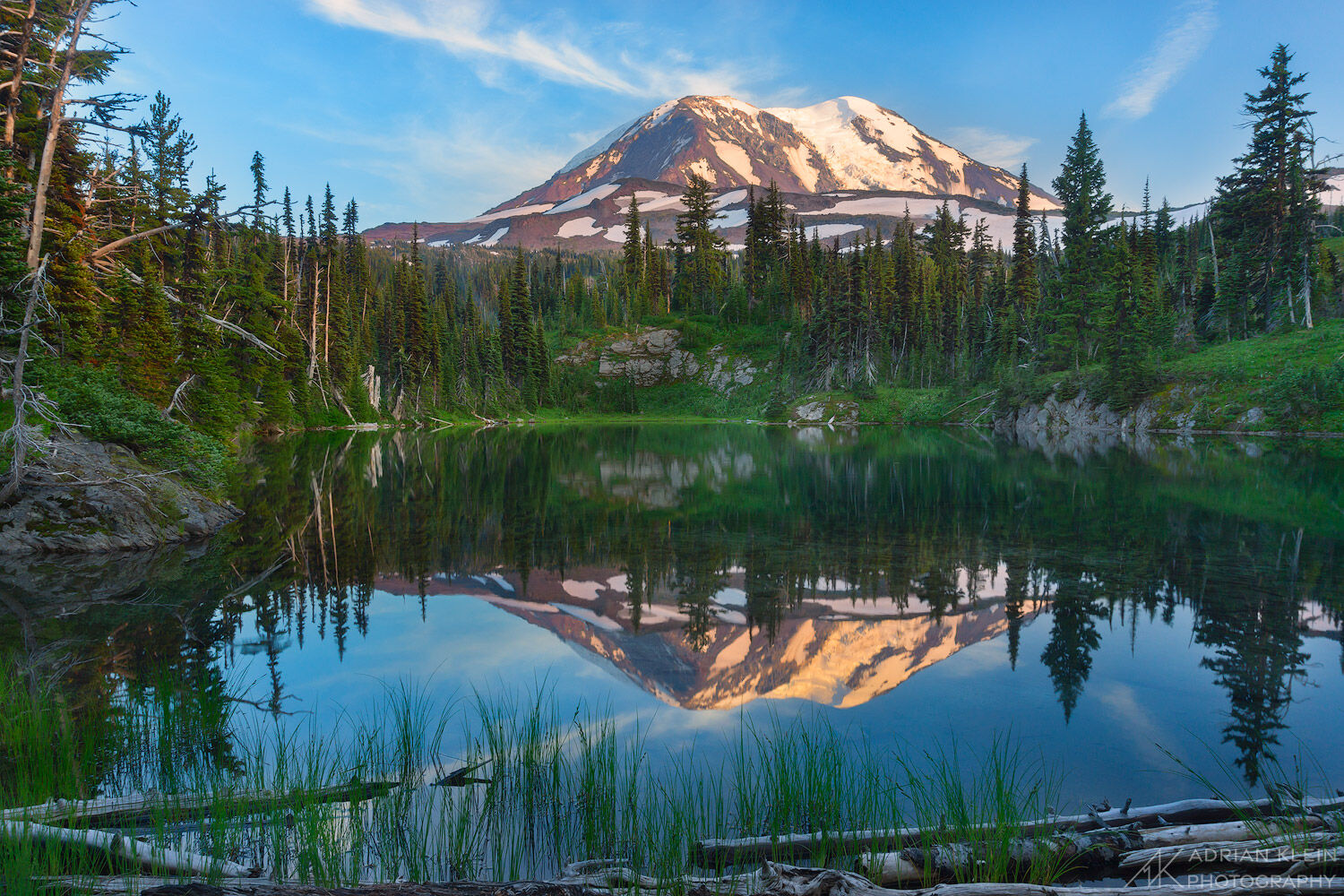 Mount Adams reflecting in a small lake in the Mount Adams Wilderness of Washington.
