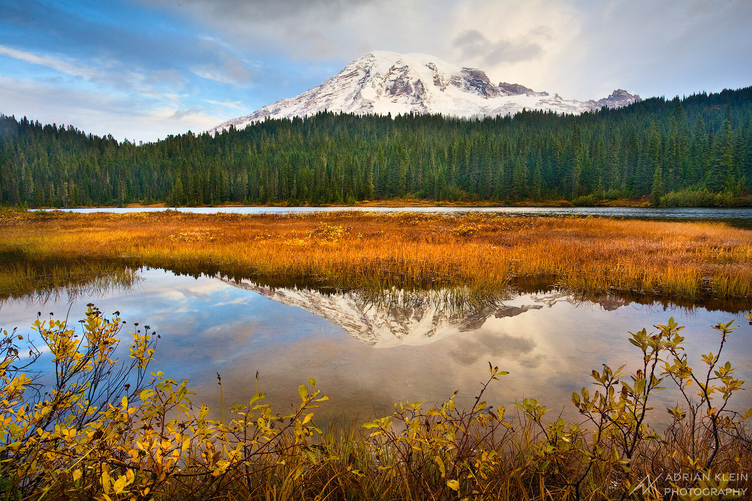 A cold fall morning with only the sound of the breeze and fresh snow on Mount Rainier as it reflects peacefully in Reflection...